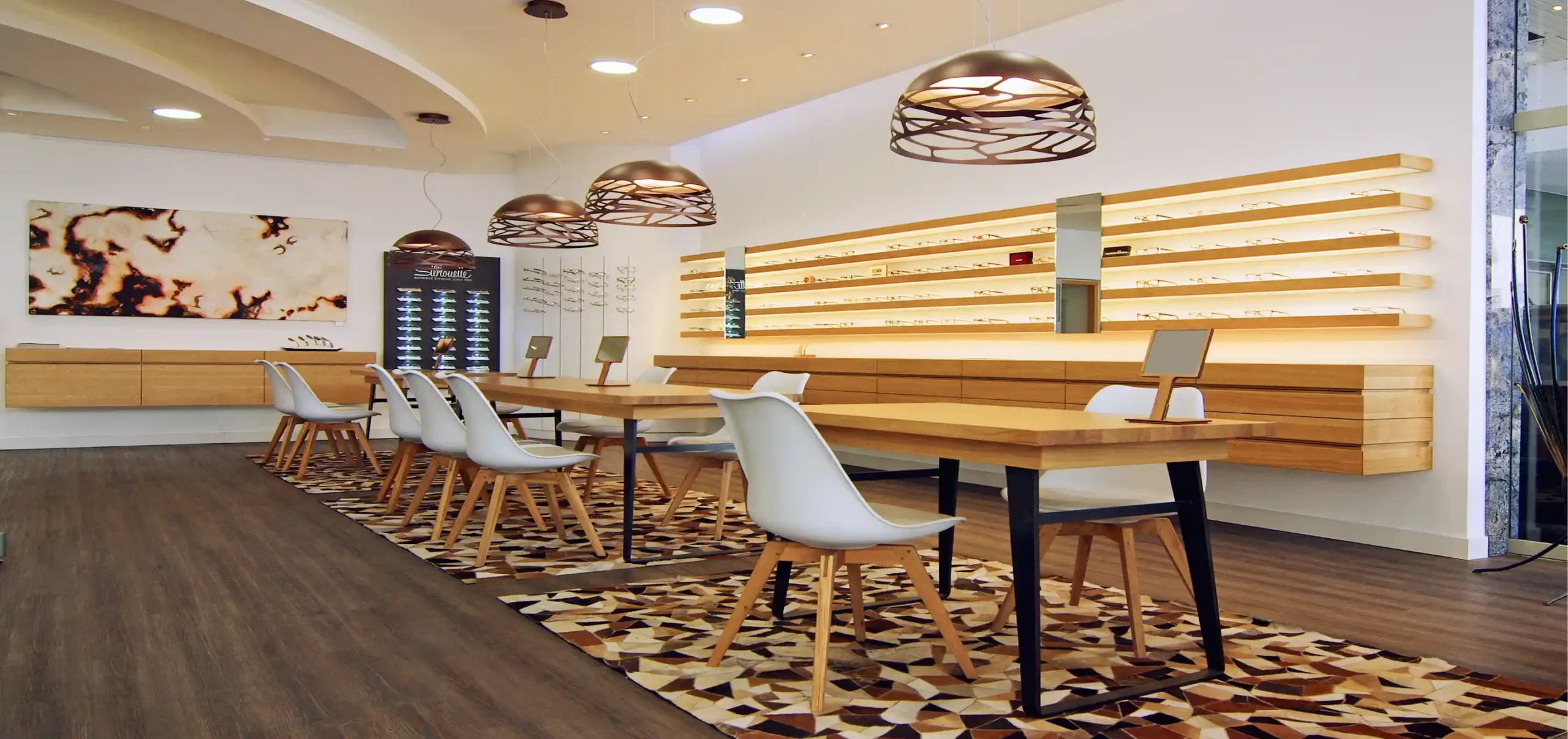Optikergeschäft, AHA Augenoptik, Freiburg, Verkaufsraum, Tisch und Bestuhlung, Regale für Brillen